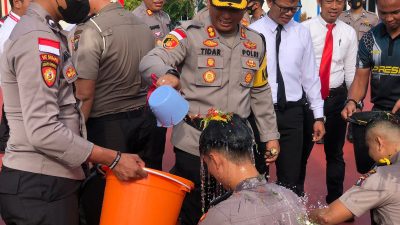 Tradisi penyiraman air kembang oleh Kapolres Bintan kepada personel yang menerima kenaikan pangkat di Mapolres Bintan, Senin (02/01/2023 ). Foto Polres Bintan